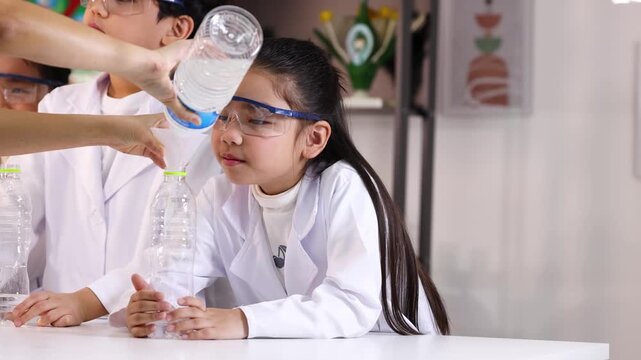 Asian Children Conducting Science Experiment with Plastic Bottle and Funnel