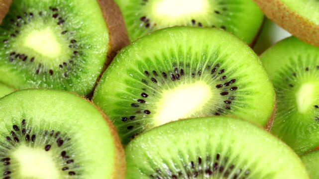 Close-up view of vibrant green kiwi fruit slices with black seeds, showcasing a healthy and refreshing food