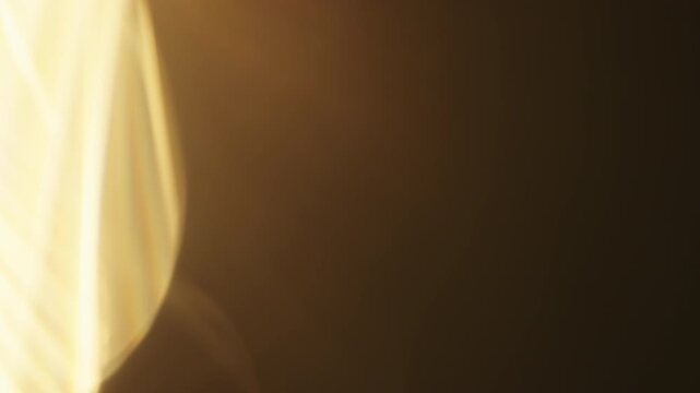 Slow motion real lens flare from back sunlight over dark background for overlay