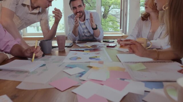Young creative professionals exchanging ideas during collaborative brainstorming workshop. Concept of design thinking, agile teamwork, innovation development.