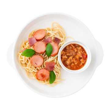 homemade spaghetti with separated sauce on white plate isolated on white background, clipping path included, Italian cuisine