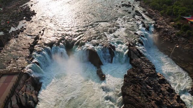 Early morning DJI Air 3 drone orbit reveals the full width of Dhuandhar Waterfall and the powerful Narmada River at Bhedaghat, Jabalpur, Madhya Pradesh, India, in late March.