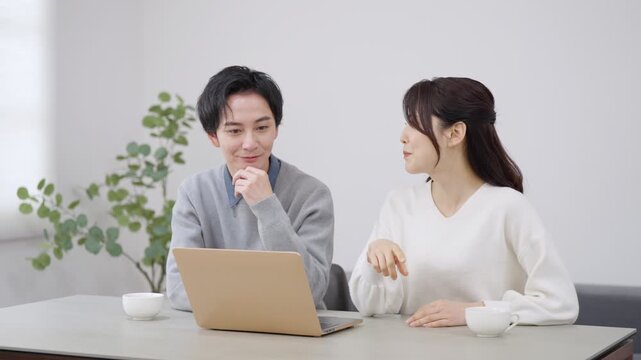 パソコンを見る夫婦・カップル