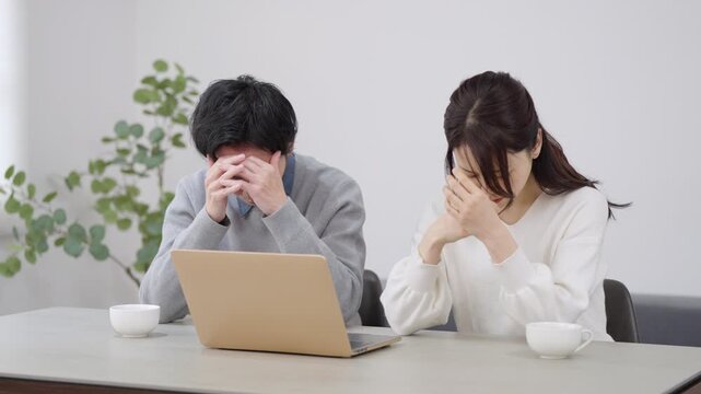 パソコンを見る夫婦・カップル
