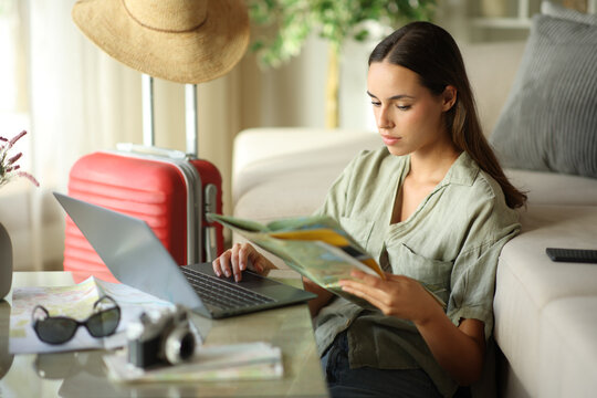 Tourist checking paper guide on vacation