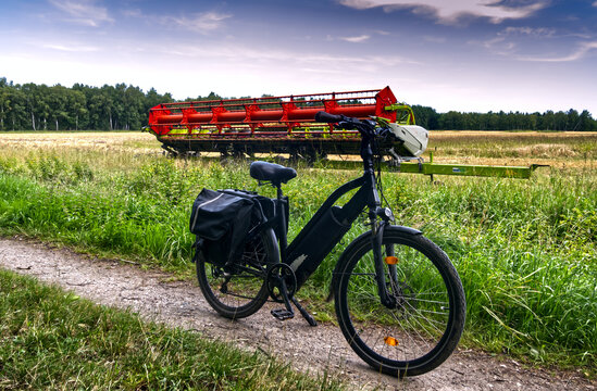 E bike on rural path with combine harvester attachment in a field, exploring german countryside and agriculture