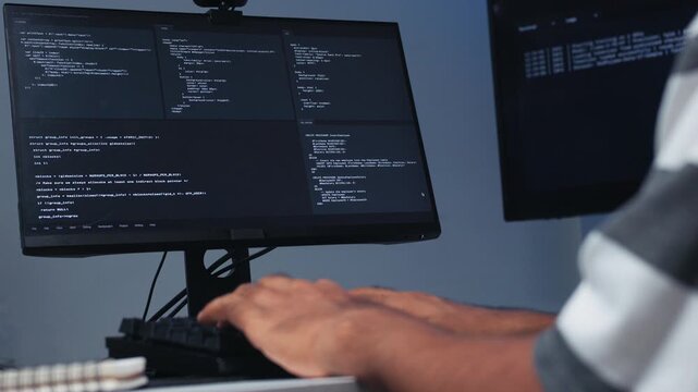 Portrait of Indian Male Programmer hand typing on keyboard,, Software Developer working on Desktop Computer, writing code with Screen Displaying Code, Application System, Cybersecurity Technology.