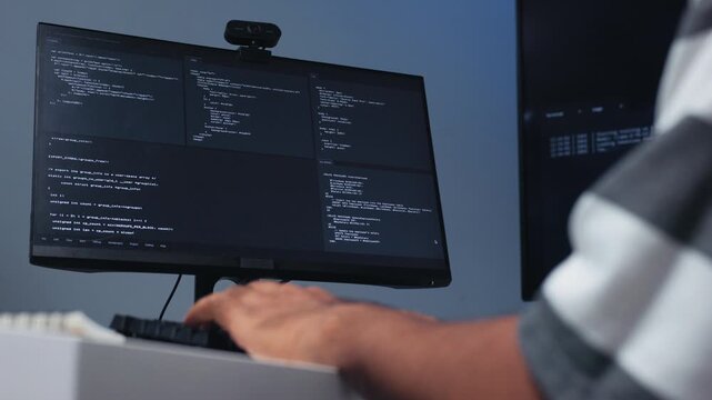 Portrait of Indian Male Programmer hand typing on keyboard,, Software Developer working on Desktop Computer, writing code with Screen Displaying Code, Application System, Cybersecurity Technology.