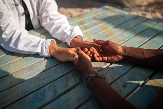 Happy interracial couple embracing and sharing a romantic moment during a tropical island getaway