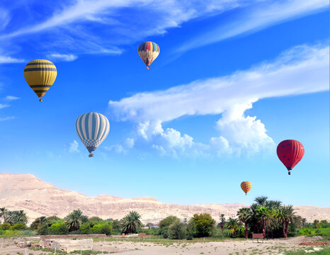 Famous tourist attraction balloon flight in Valley of Kings, Luxor, Egypt. Air balloons over the Theban Necropolis, Luxor, Egypt. Topic of vacation, travel, trip abroad on vacation, cruises and tours