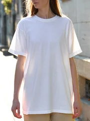 Woman wearing a plain white t-shirt and tan pants outdoors © 4Max