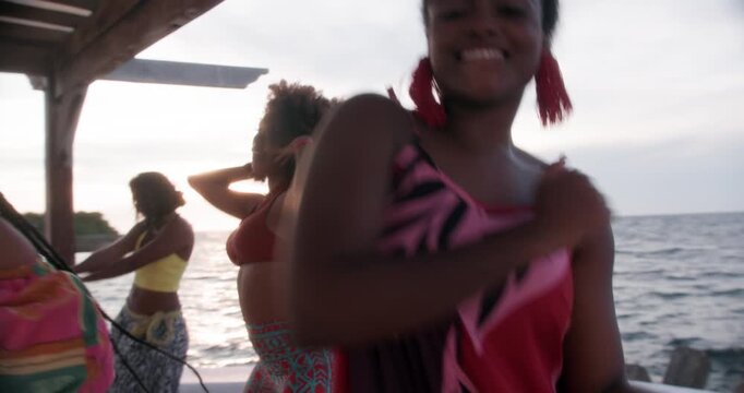 Colombian girls dancing salsa attractively on a pier, Cartagena