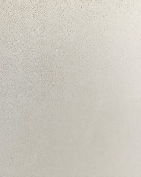 A close up view of a smooth light grey textured surface with a subtle gradient and soft shadows