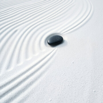 abstract wabi-sabi garden extreme close up raked white zen garden sand parallel curved lines intersecting single smooth black river stone profound minimalist serenity