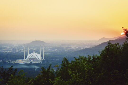 Islamabad, Pakistan - 12th september, 2023: The Faisal Mosque - fifth-largest mosque in the world. Major tourist attraction in Pakistan. Margalla hills famous sunset viewpoint panorama