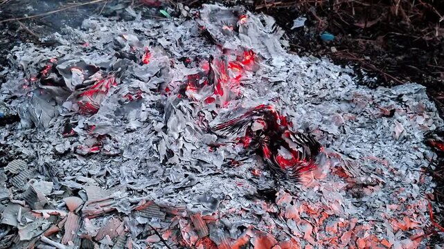 Embers from burning waste paper