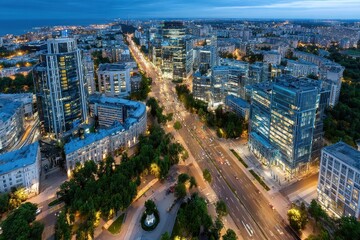Naklejka premium Elevated cityscape at dusk with illuminated roads and buildings