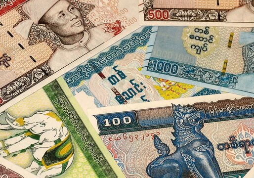 Myanmar kyat money bills in pile on table. Myanmar MMK currency cash close up
