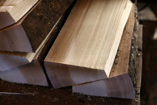 Freshly split firewood stacked in a traditional woodworking workshop