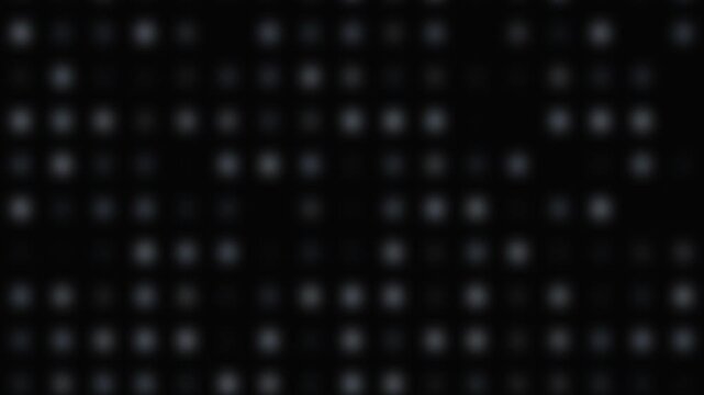 Blurred white dots arranged in a grid pattern on a black background for a seamless loop