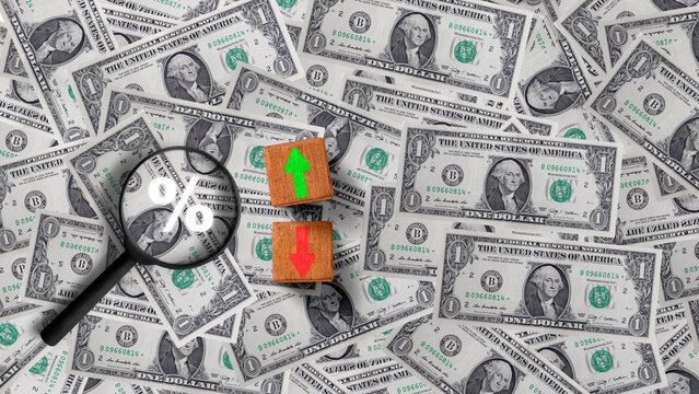 A magnifying glass showing a percent sign next to up and down wooden arrows on US dollar bills, depicting interest rates, inflation, and financial analysis. Concept of business growth or finance