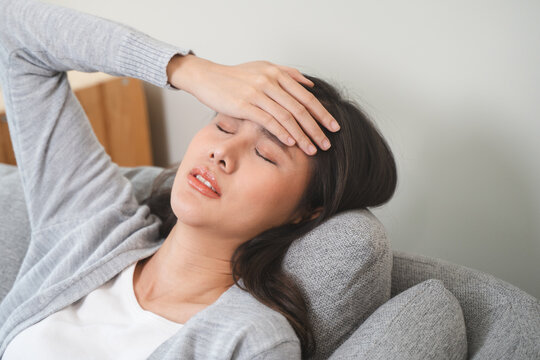 Young Asian females feeling dizzy after standing too fast, have symptoms of low blood pressure
