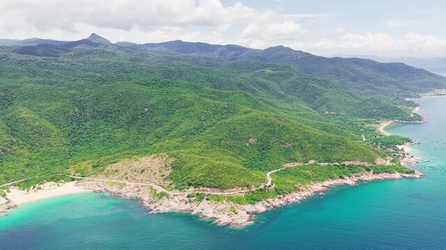 Cinematic aerial view of Vinh Hy Bay coastal road and emerald sea in Ninh Thuan Vietnam