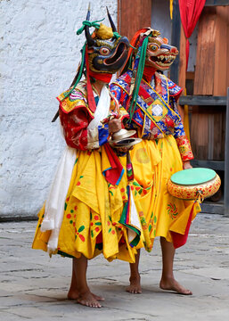Bhutan, In the village of Bumthang, monks in colorful costumes dance during the annual Jakar festival. blurred background