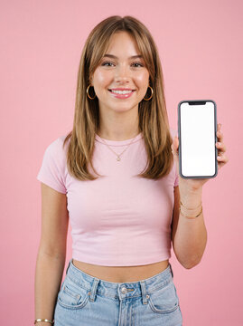 Smiling woman holding smartphone outdoors