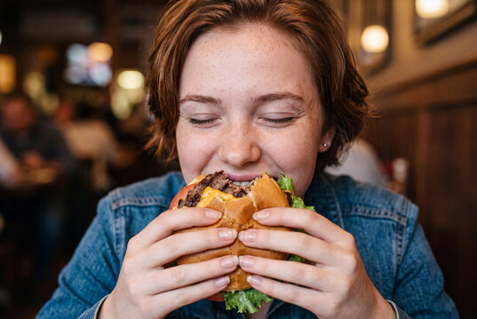 Person enjoying delicious food at night