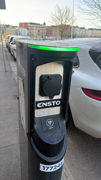 Electric Vehicle Plugged into Curbside Charging Point