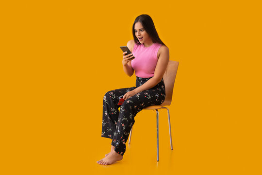 Indian girl shopping online through smartphone using credit card