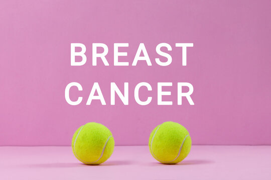 Breast cancer awareness concept with tennis balls and typography on pink background