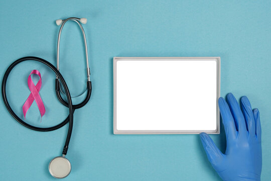 Breast cancer awareness mockup with stethoscope pink ribbon and blank frame on blue background