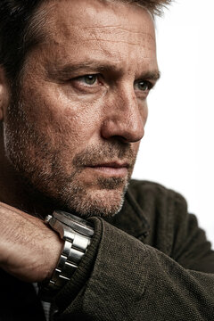 Portrait of a mature man with stubble wearing a watch