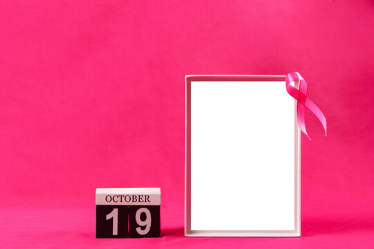 Breast cancer awareness concept with pink ribbon blank frame and October 19 calendar on pink background