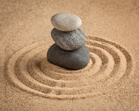 Japanese Zen stone garden - relaxation, meditation, simplicity alongside balance concept - pebbles and raked sand tranquil calm scene, with symbol