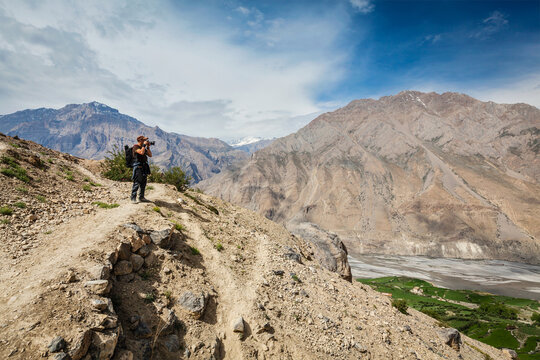 Scene featuring photographer taking photos in Himalayas mountains. Spiti valley, Himachal Pradesh, India
