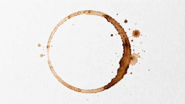 A large coffee stain with splatters on a white background with focus on splatter paper brown liquid artistic watercolor effect.