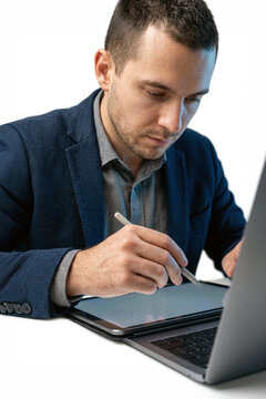 Man using a stylus on a tablet in a modern office