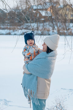 Portrait of Mother and Baby in Winter Wonderland