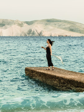 Woman standing on pier at Croatia sunset