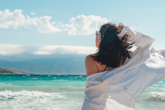 Woman in swimsuit walking on Croatia beach