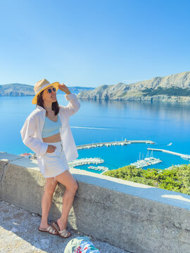 Woman in white dress at Croatia sea viewpoint