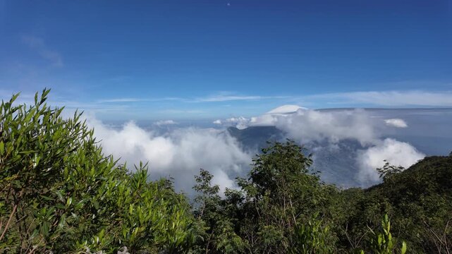 4k video footage of Views of Mount Sumbing ridge with volcanic cliff rocks, Wonosobo, Indonesia with blue sky in the morning.