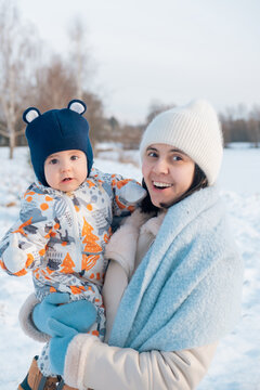 Smiling Mother and Baby Enjoying a Winter Day