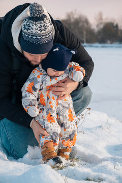 Father and Baby Enjoying Snowy Day Together.