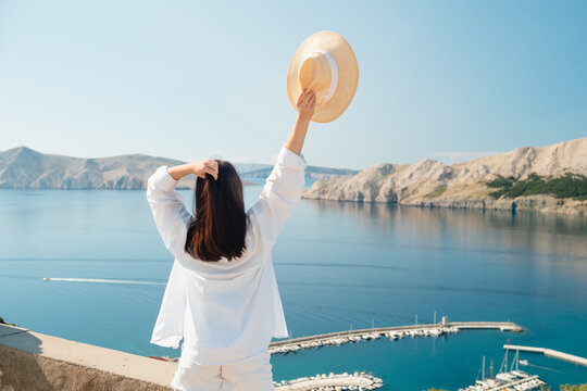 Woman in white dress at Croatia sea viewpoint