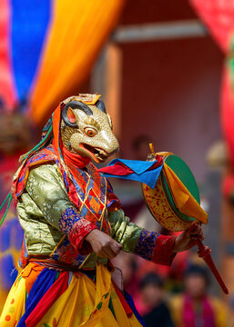 Bhutan, In the village of Bumthang, monks in colorful costumes dance during the annual Jakar festival. blurred background