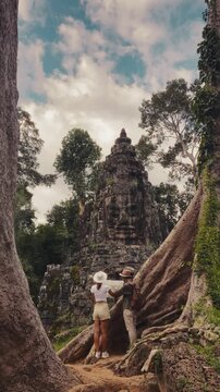 Tourist Couple Reading Map At Victory Gate Bayon Temple Angkor Thom Cambodia